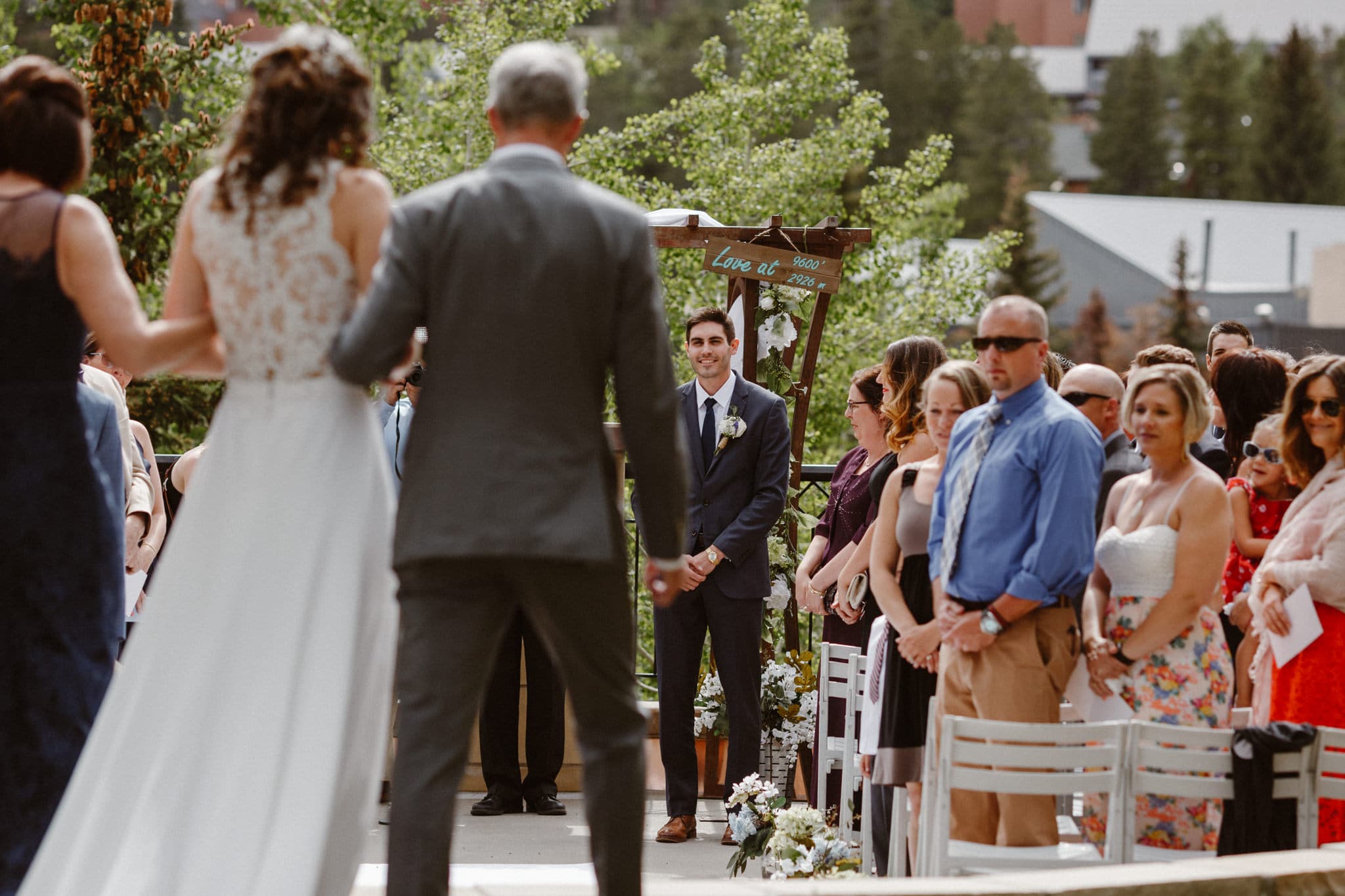 Bride and parents walking down the aisle at Main Street Station wedding, Breckenridge wedding photographer