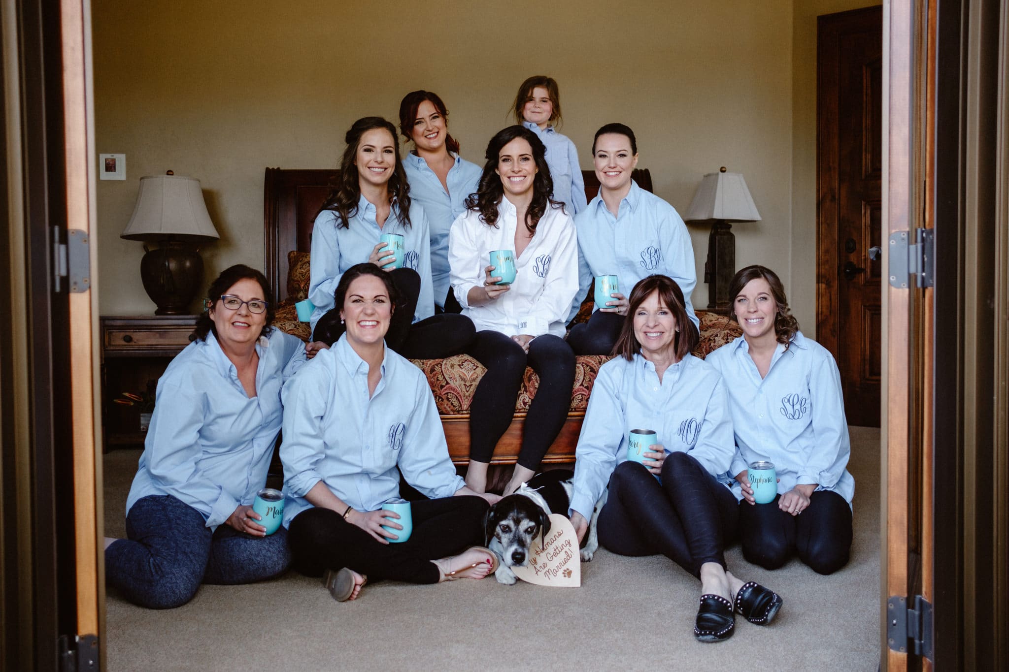 Bride and bridesmaids in matching monogrammed shirts while getting ready