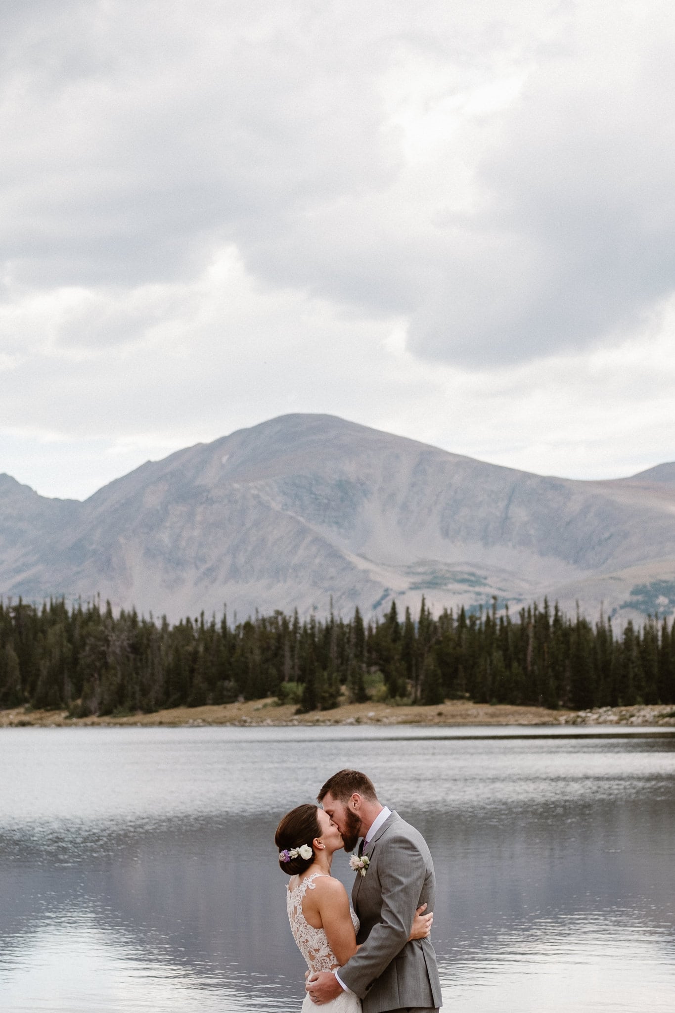 Colorado mountain elopement photographer, alpine lake adventure wedding, Boulder wedding photographer, outdoor ceremony, first kiss