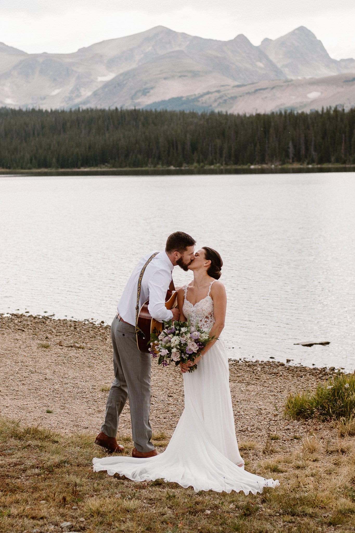 Colorado mountain elopement photographer, alpine lake adventure wedding, Boulder wedding photographer, groom playing guitar and singing to bride