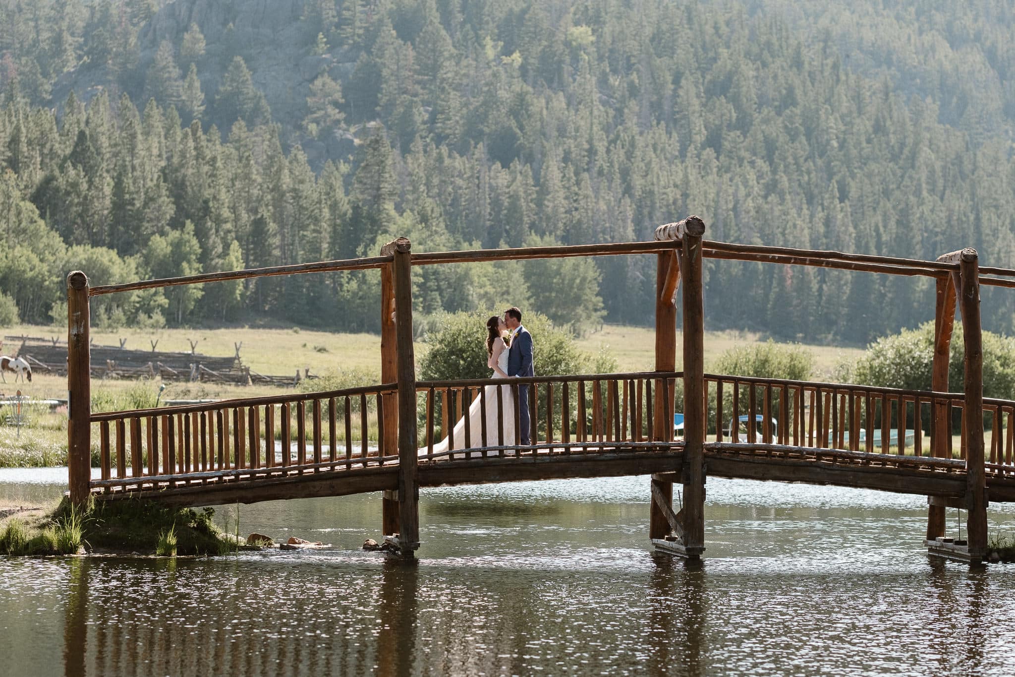 Red Feather Lakes elopement photographer, Colorado intimate cabin wedding, bride and groom first look on bridge