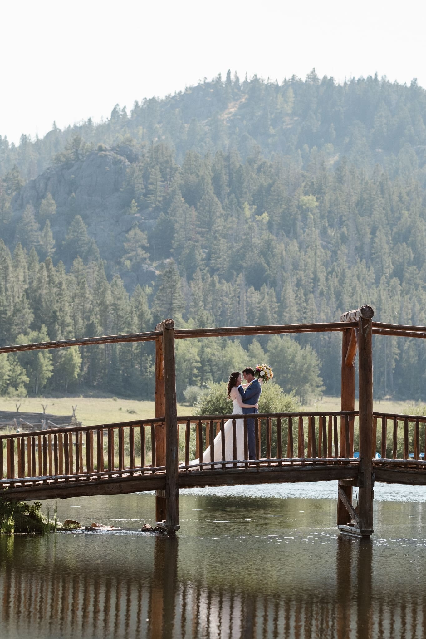 Red Feather Lakes elopement photographer, Colorado intimate cabin wedding, bride and groom first look on bridge