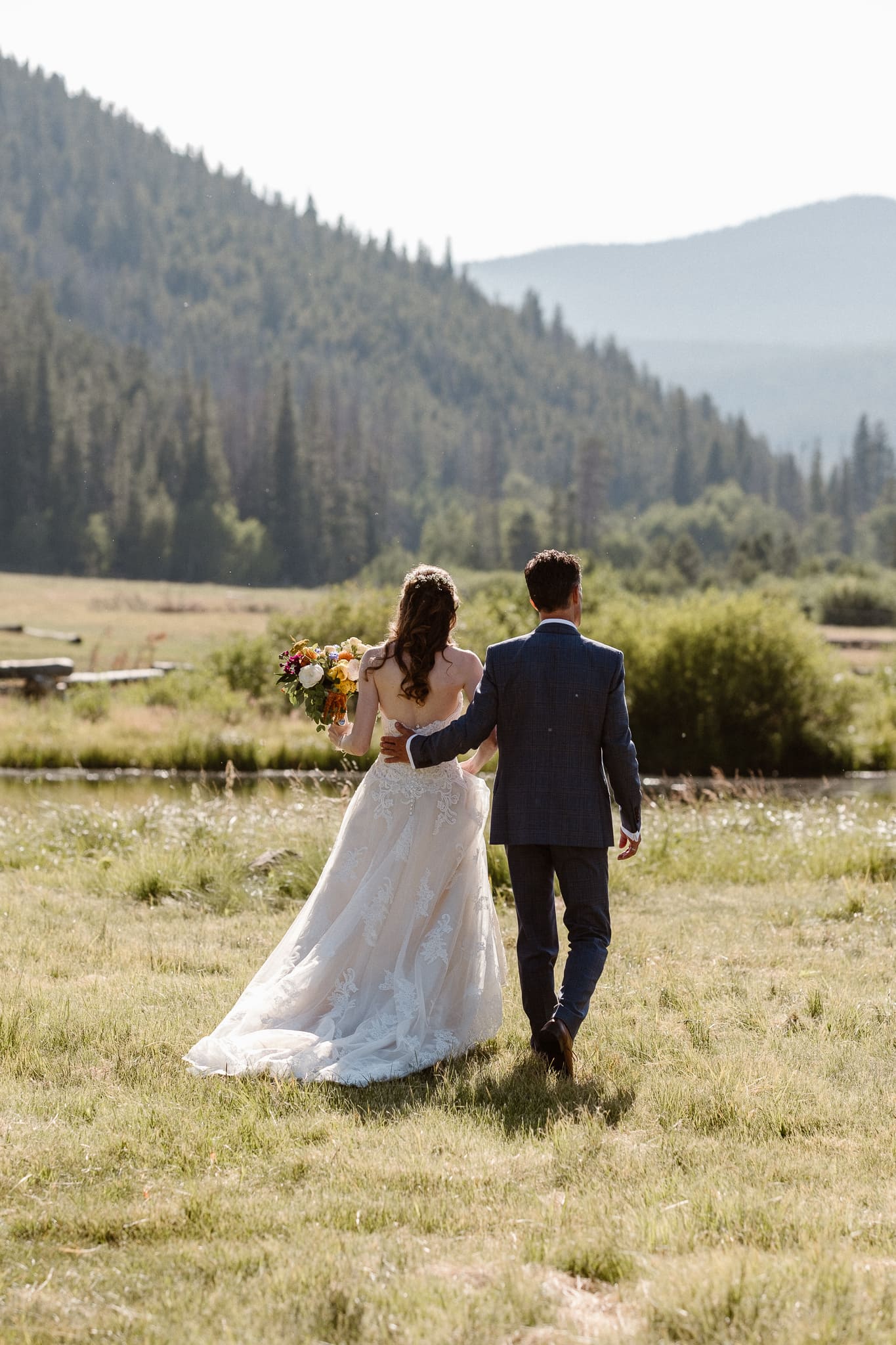 Red Feather Lakes elopement photographer, Colorado intimate cabin wedding, bride and groom hiking through alpine meadow