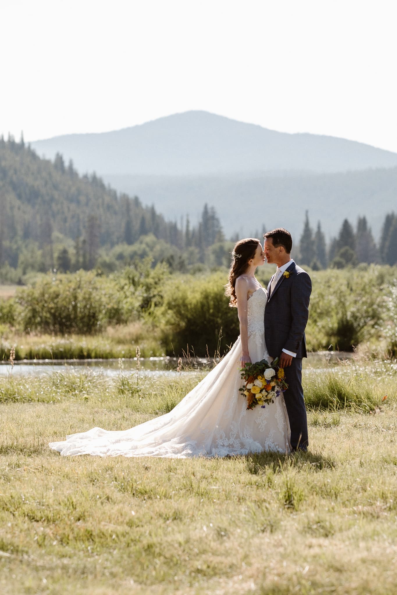 Red Feather Lakes elopement photographer, Colorado intimate cabin wedding, bride and groom portraits in mountain meadow, hazy light wedding portraits