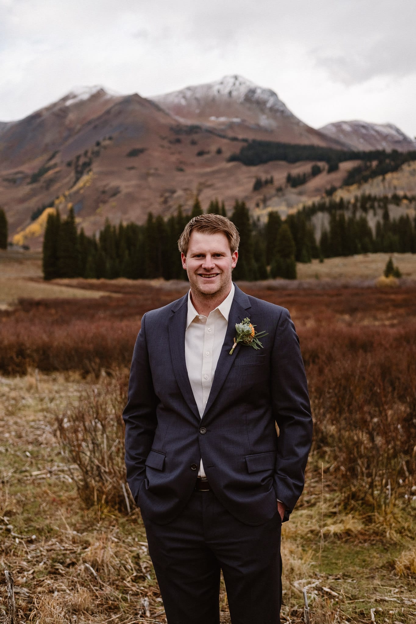 Crested Butte Wedding Photographer, Scarp Ridge Lodge intimate elopement, self solemnized elopement in Colorado, bride and groom portraits, Colorado mountain adventure wedding, groom with orange and green boutonniere by From the Ground Up Flowers