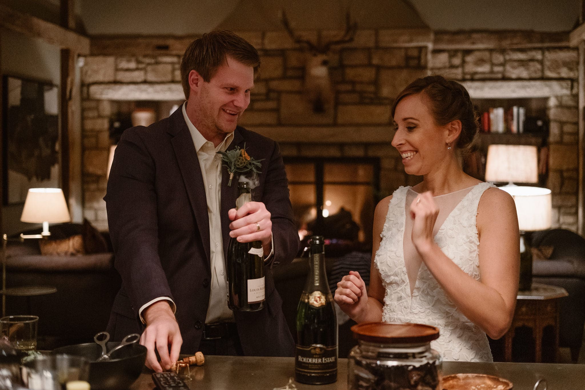 Crested Butte Wedding Photographer, Scarp Ridge Lodge intimate elopement, bride and groom popping champagne, luxury mountain lodge in Colorado