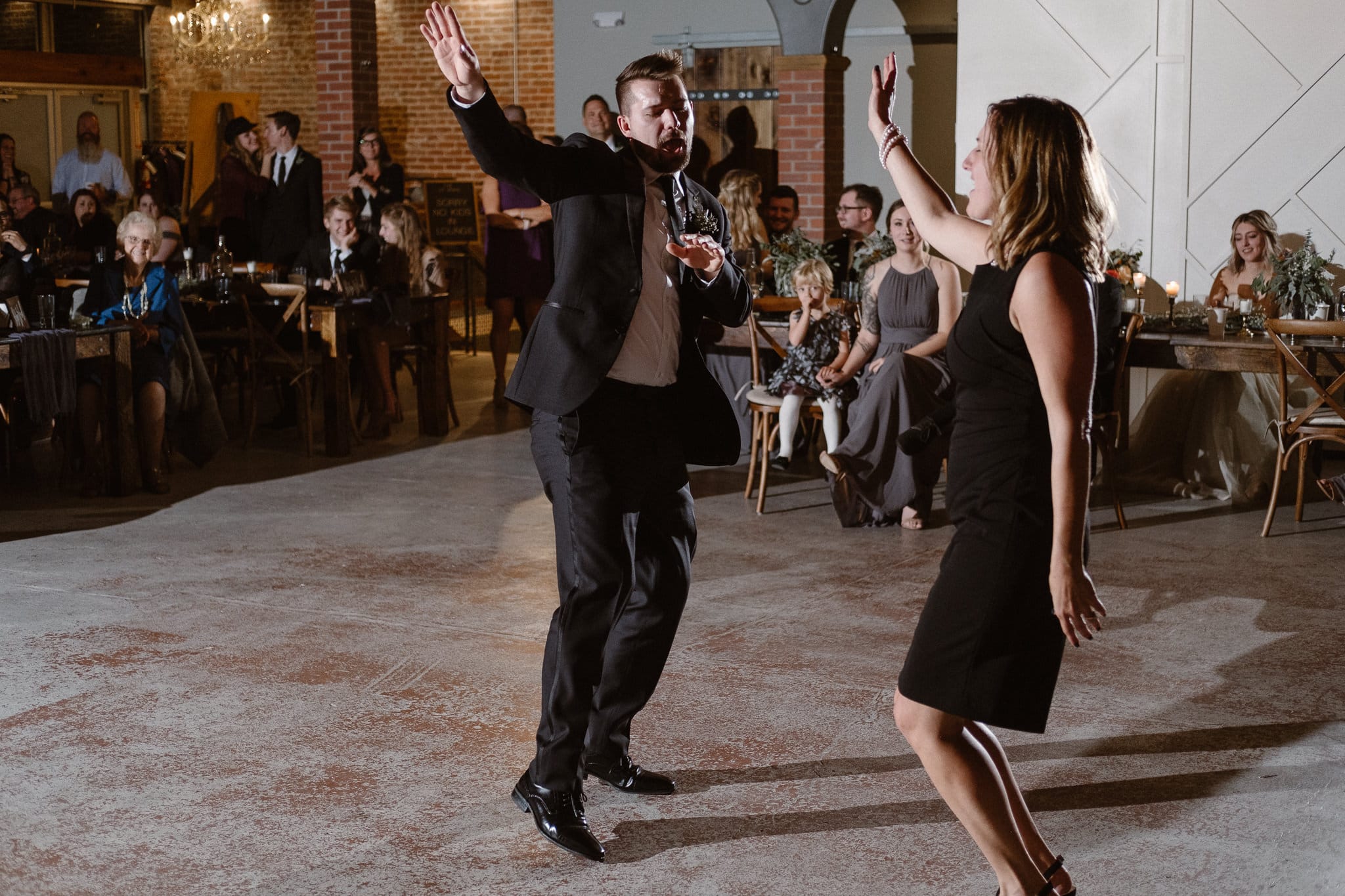 St Vrain Wedding Photographer | Longmont Wedding Photographer | Colorado Winter Wedding Photographer, Colorado industrial chic wedding ceremony, groom dancing with his mother, off camera flash photography reception lighting