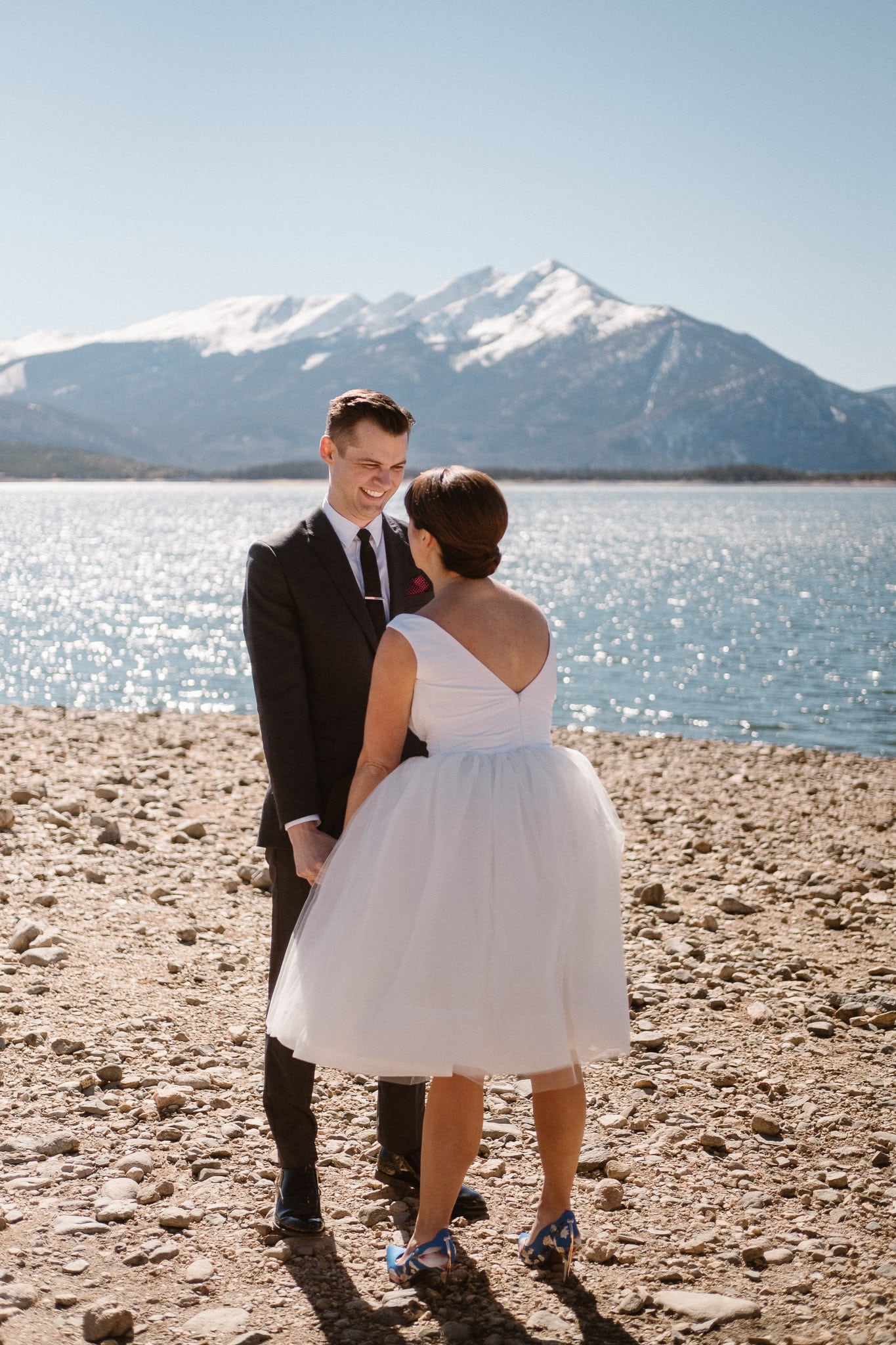Bride and groom first look at Lake Dillon in Summit County for Silverthorne Pavilion wedding, Colorado wedding photographer