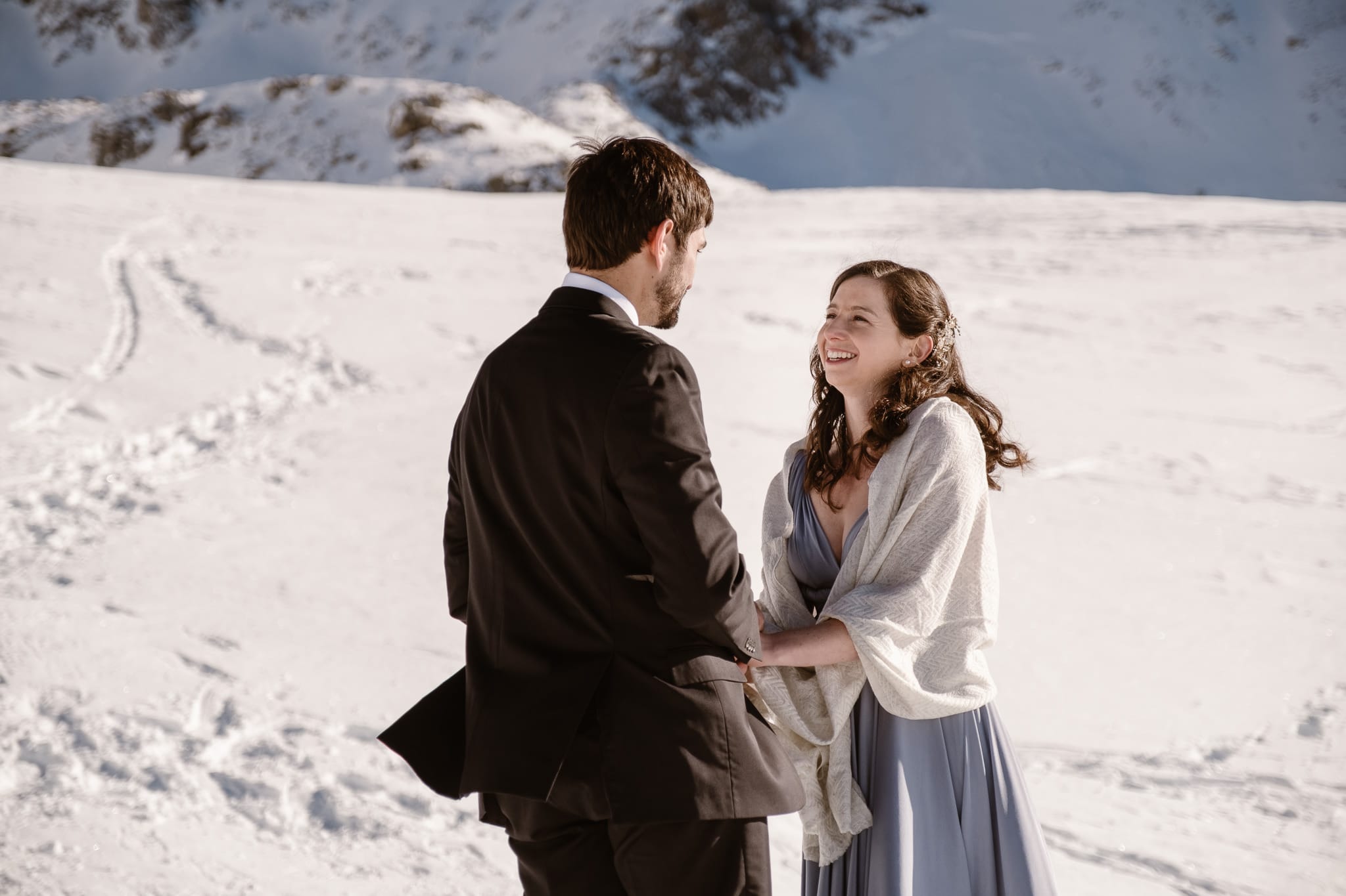 Bride and groom exchanging vows in snow covered mountains of Colorado, winter elopement photography