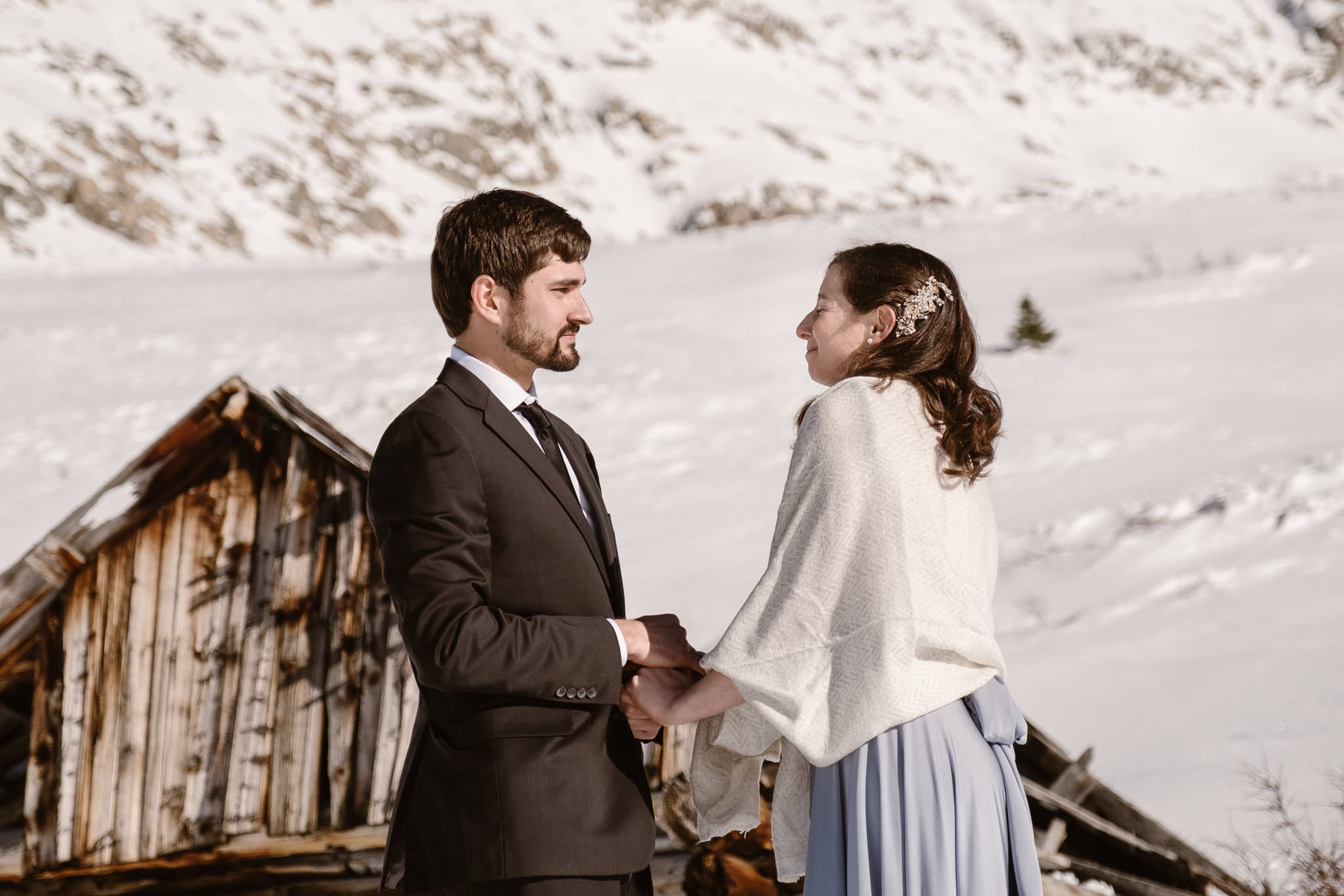 Bride and groom exchanging vows in snow covered mountains of Colorado, winter elopement photography