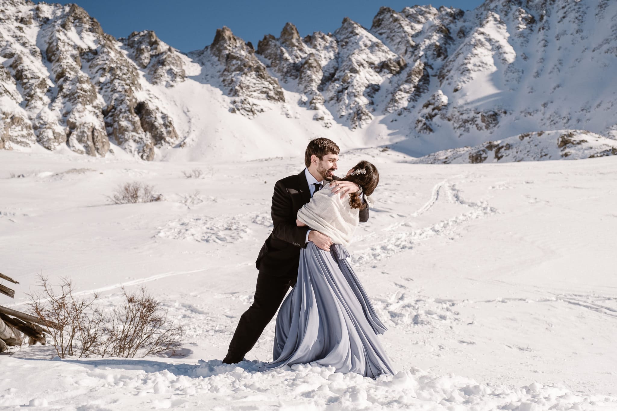 Bride and groom first kiss, winter mountain elopement, Colorado snow elopement, winter wedding