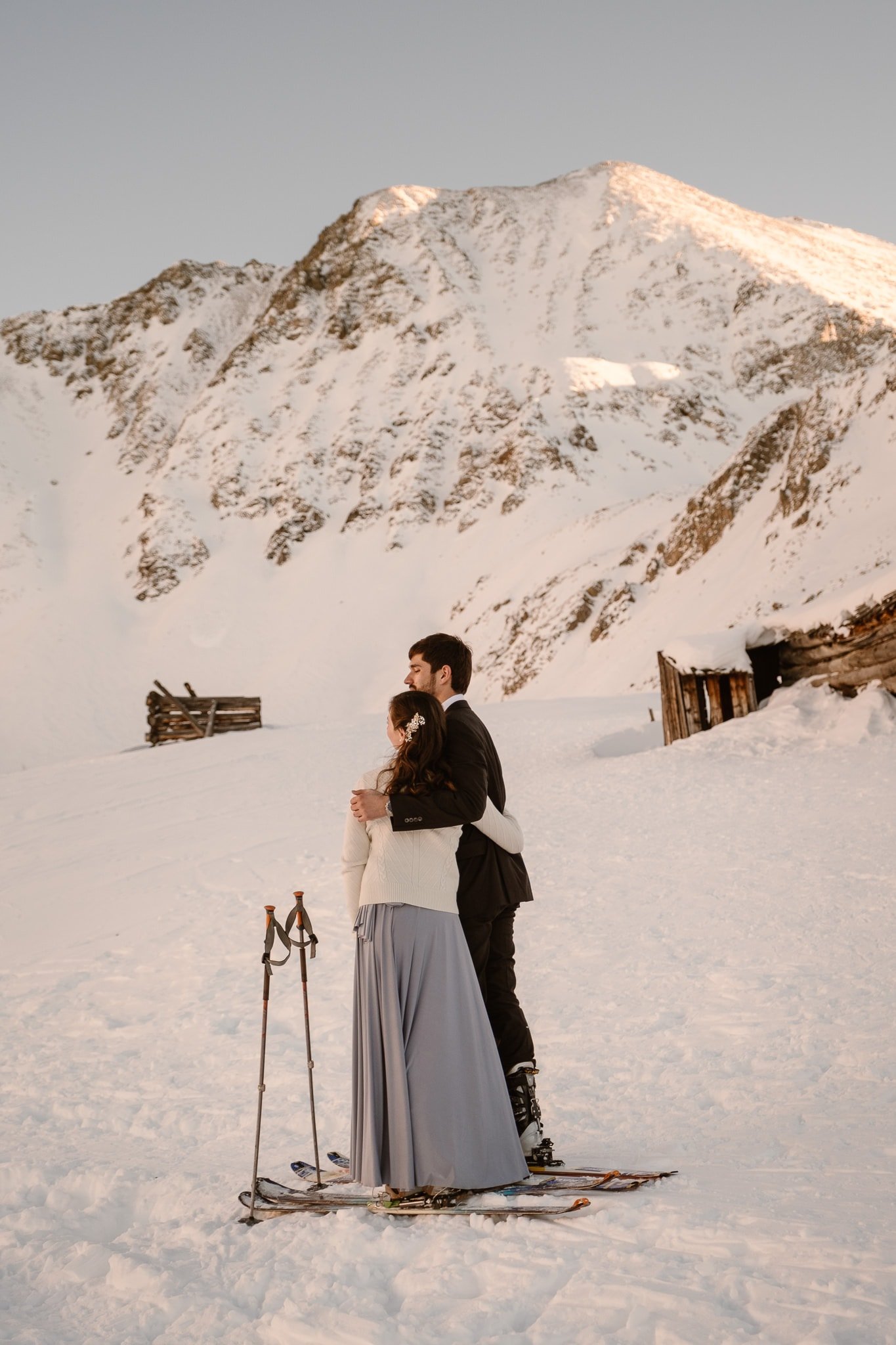 Bride and groom at Mayflower Gulch in Colorado, backcountry skiing elopement, snow covered mining cabins