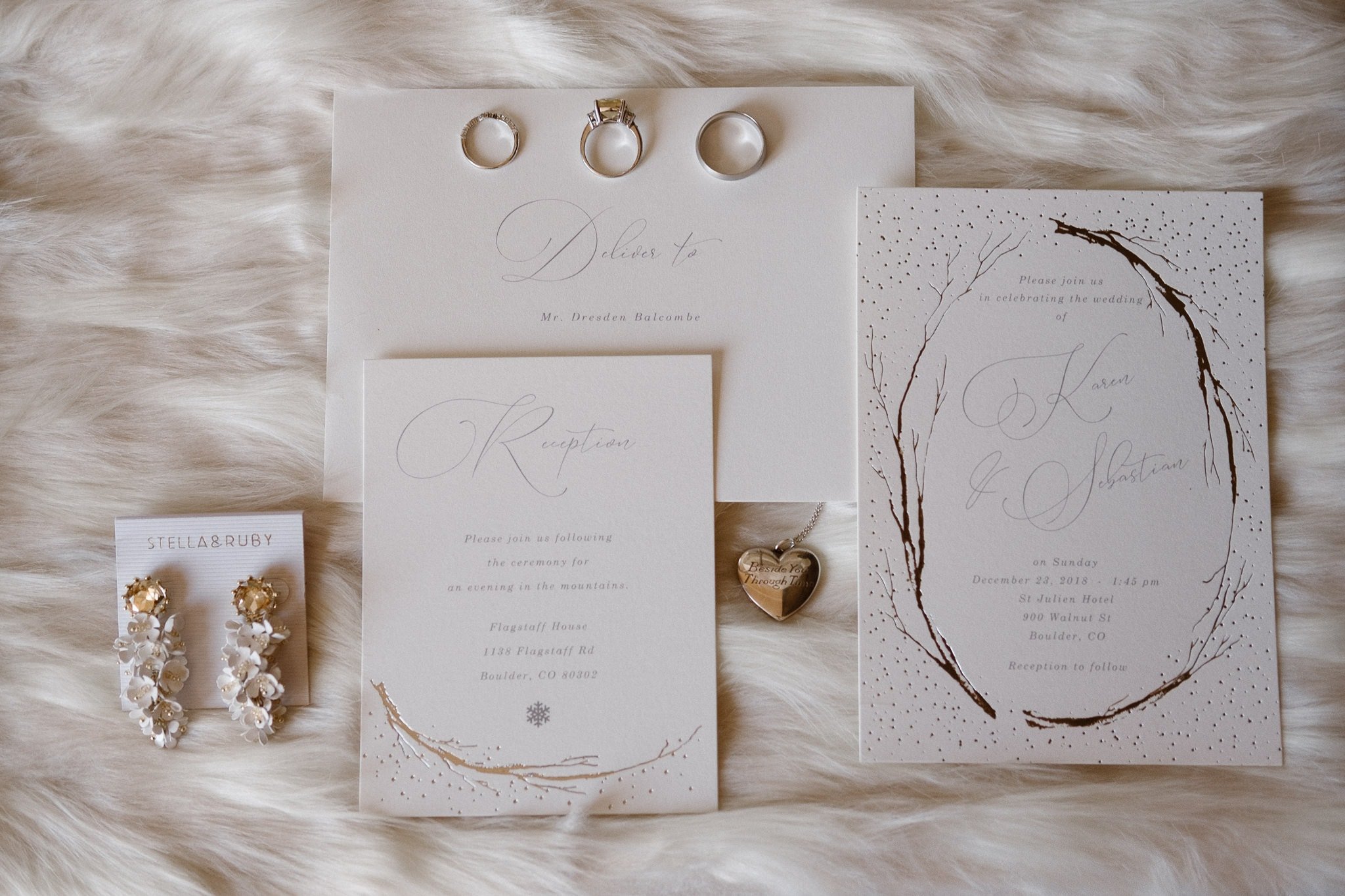 Elegant white and silver wedding invitations and jewelry on fur