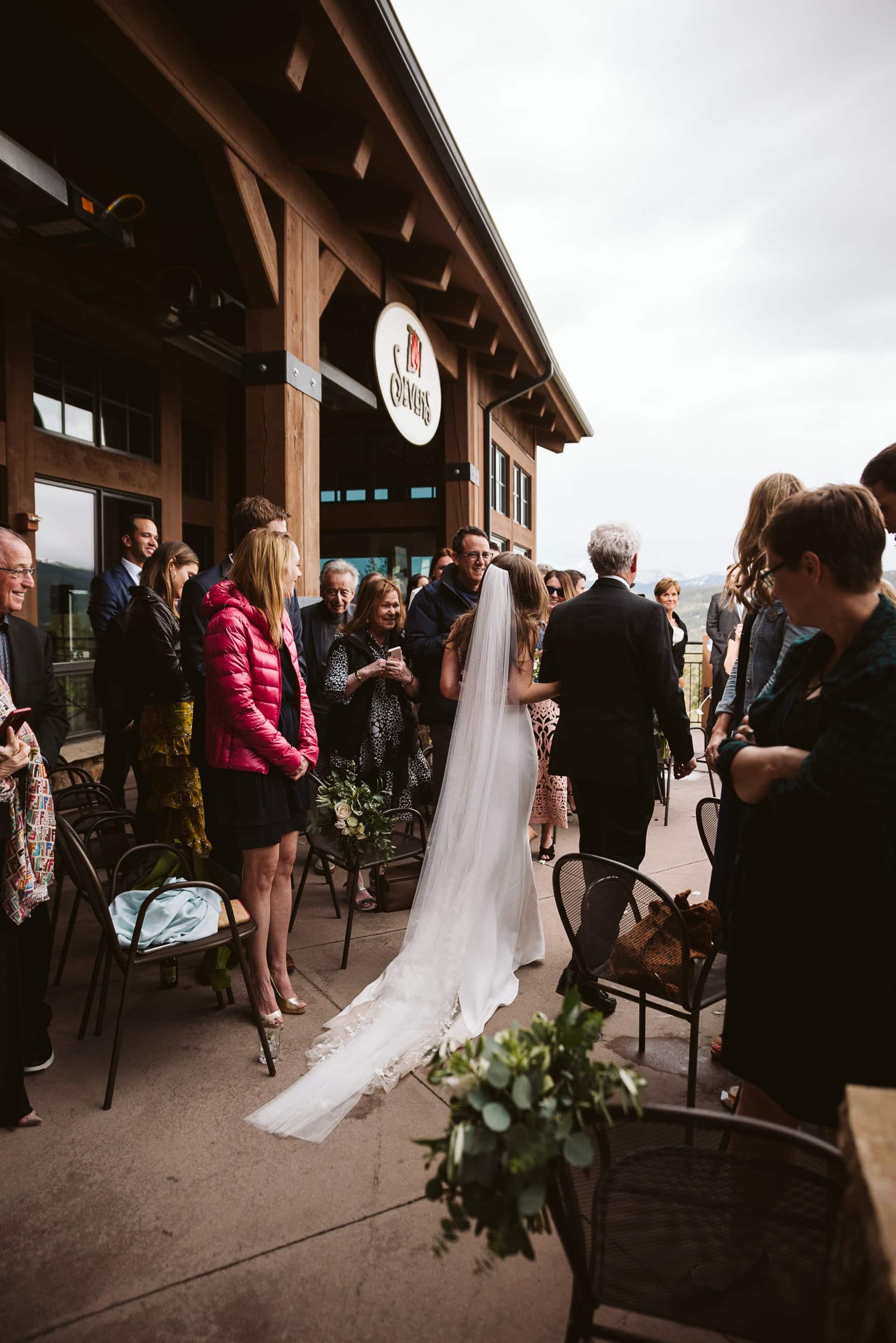 Bride and her father walking down the aisle for wedding ceremony at Breckenridge Ski Resort, Colorado mountain wedding