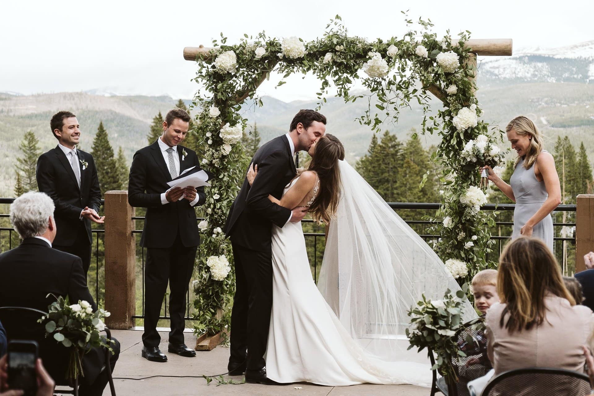 Bride and groom first kiss, Wedding ceremony at Sevens at Breckenridge Ski Resort, Colorado mountain wedding photographer