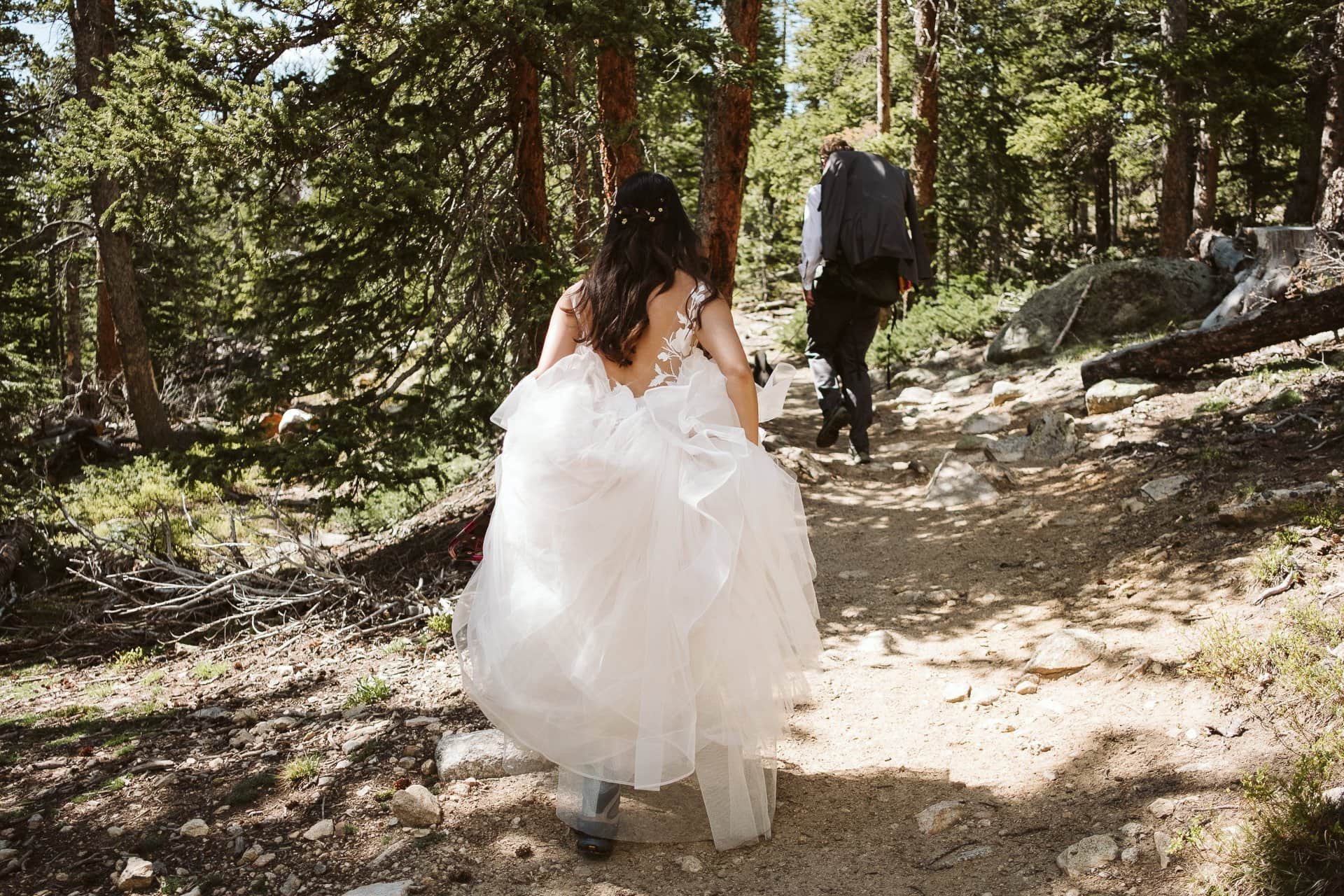 Bride and groom hiking in the Colorado mountains, Indian Peaks Wilderness adventure elopement, Colorado elopement photographer