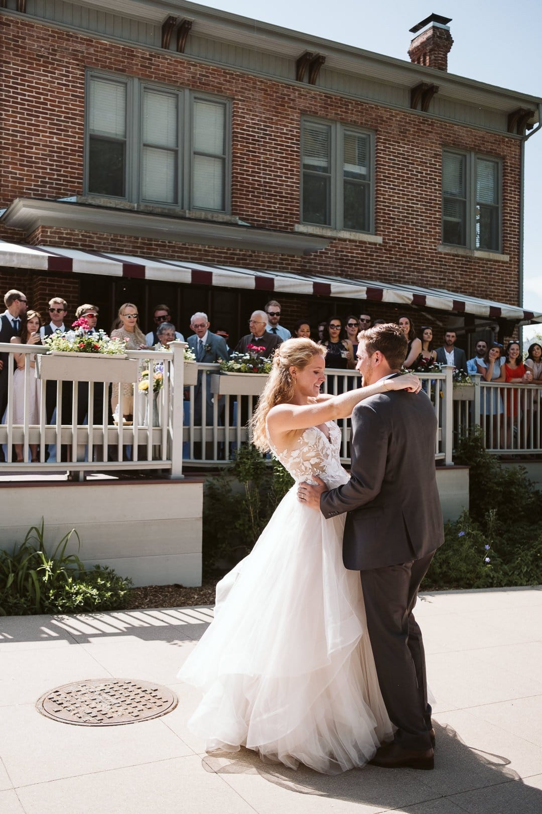 Bride and groom first dance outdoors in the sun at CU Koenig Alumni Center wedding, Boulder wedding photographer