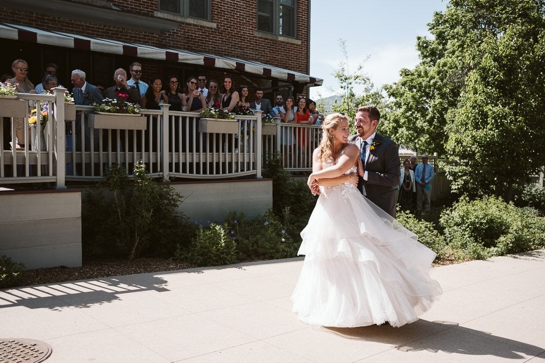 Bride and groom first dance outdoors in the sun at CU Koenig Alumni Center wedding, Boulder wedding photographer