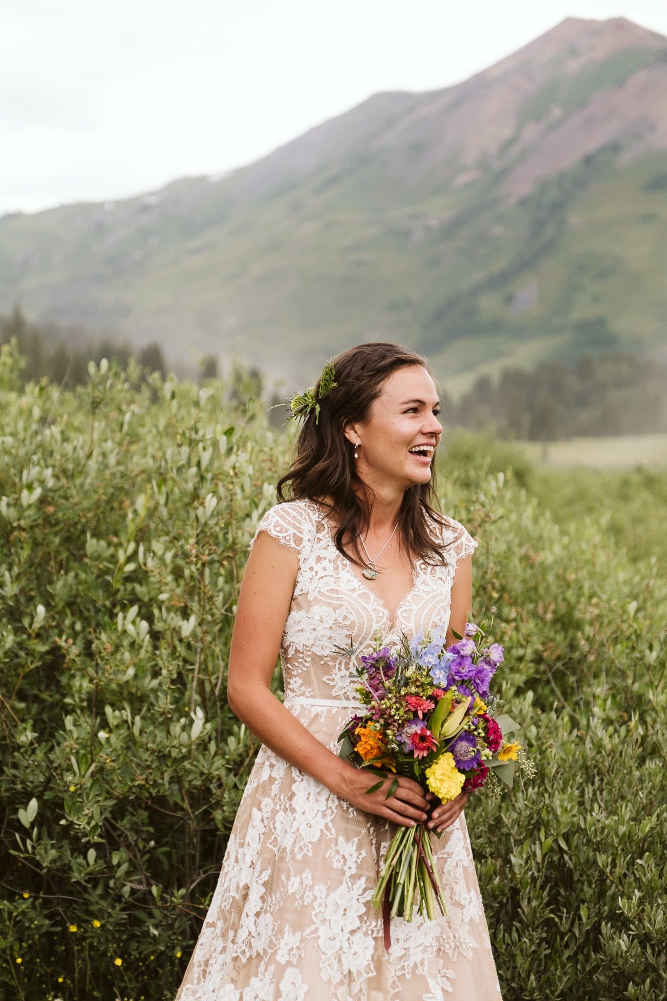 Bride with wildflower wedding bouquet in Crested Butte, bride wearing Watters Aella gown