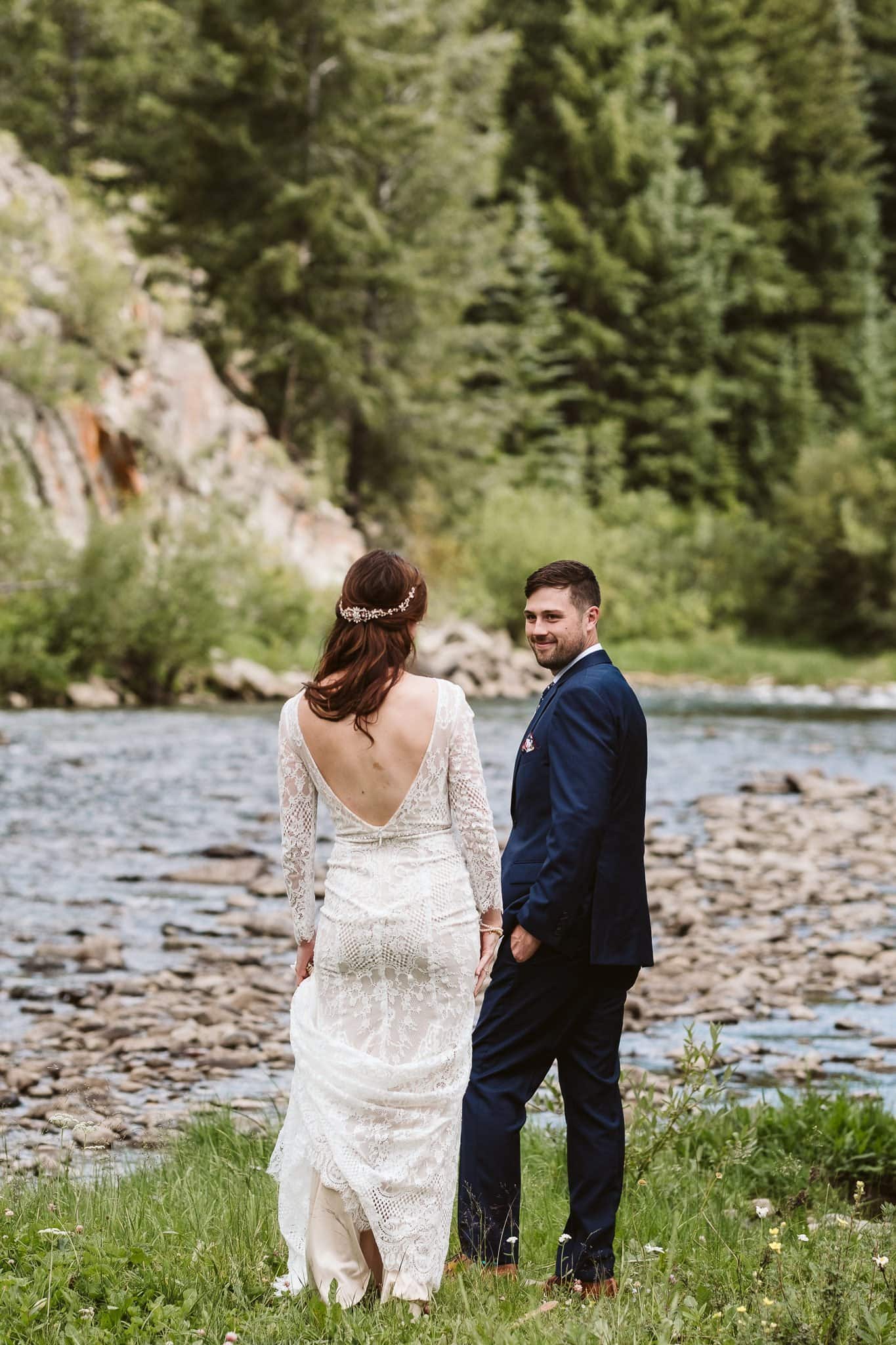 Bride and groom first look by a river in Colorado, Rivertree Lodge wedding photographer