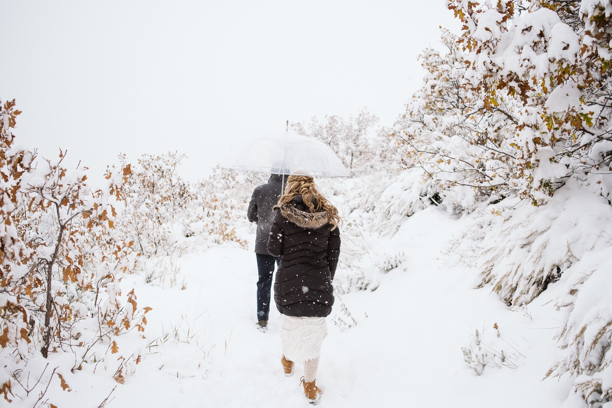Bride and groom hiking in snow at Steamboat Springs elopement in winter