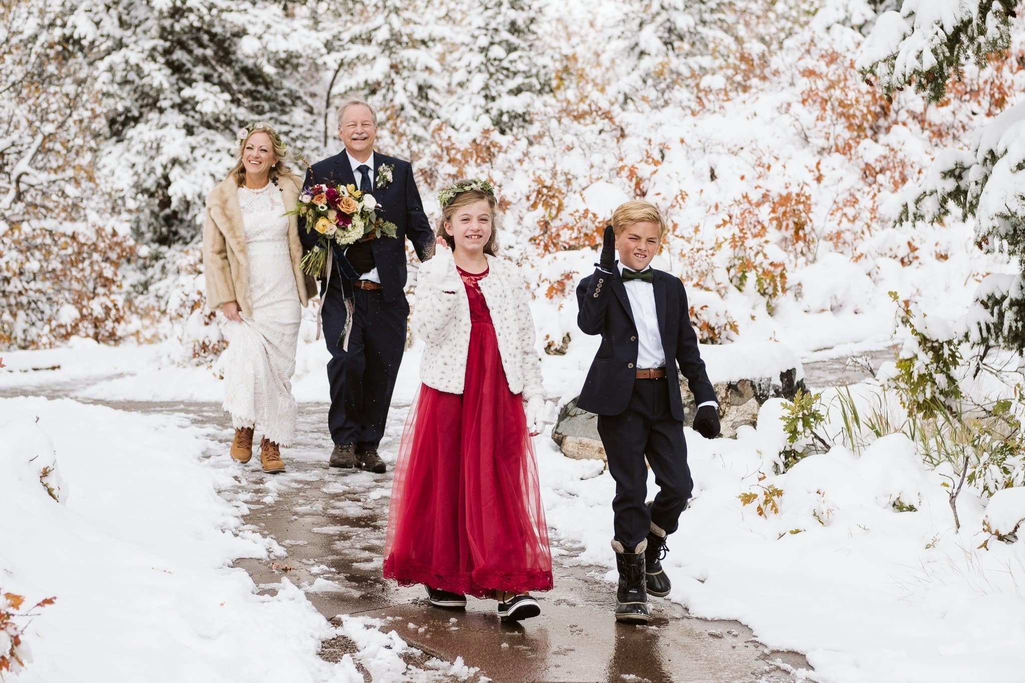 Bride walks down the aisle with her father and children at Fish Creek Falls wedding in Steamboat Springs