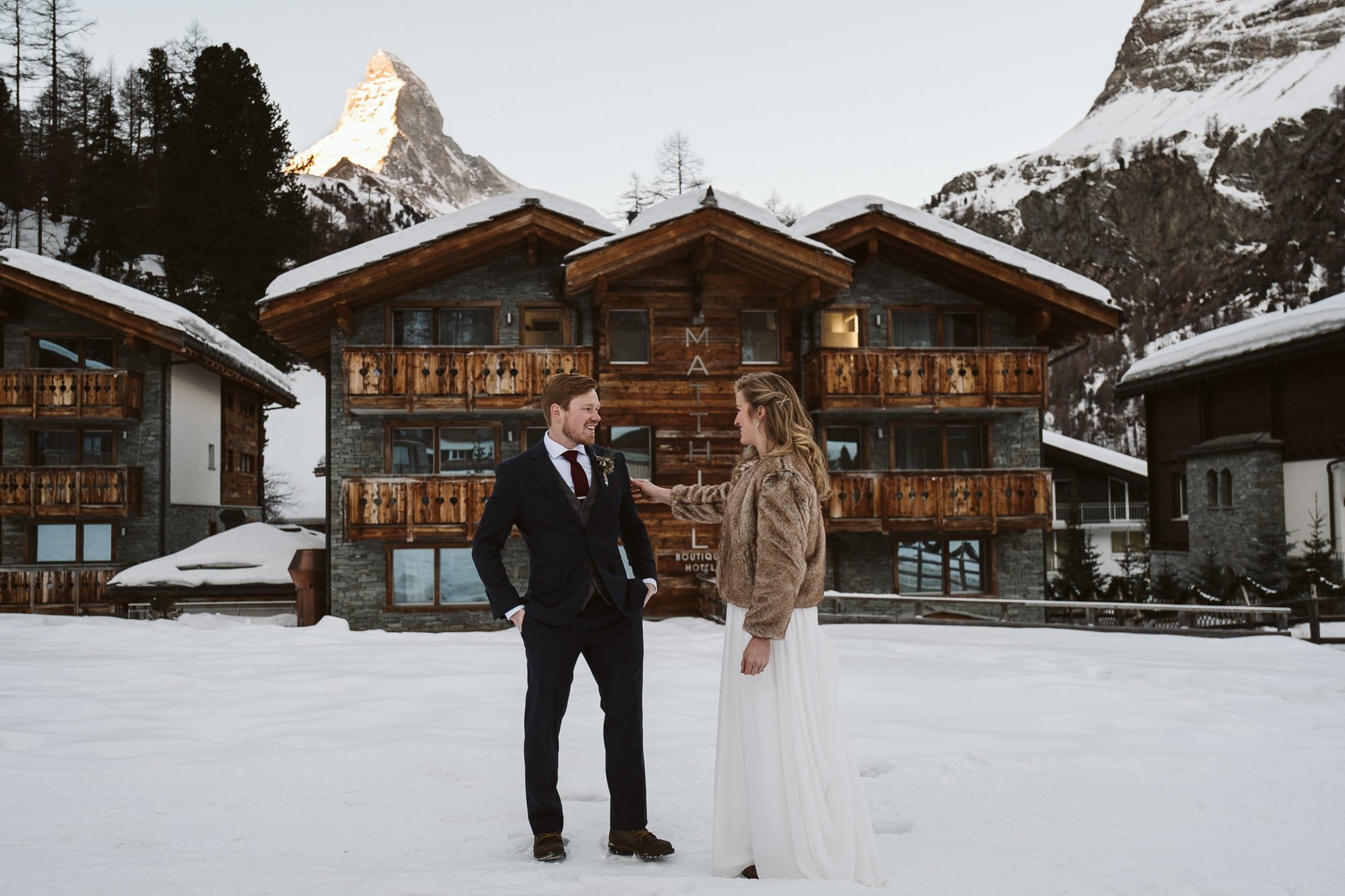 Bride and groom first look outside of Matthiol Boutique Hotel in Zermatt. Switzerland adventure elopement at Matterhorn.