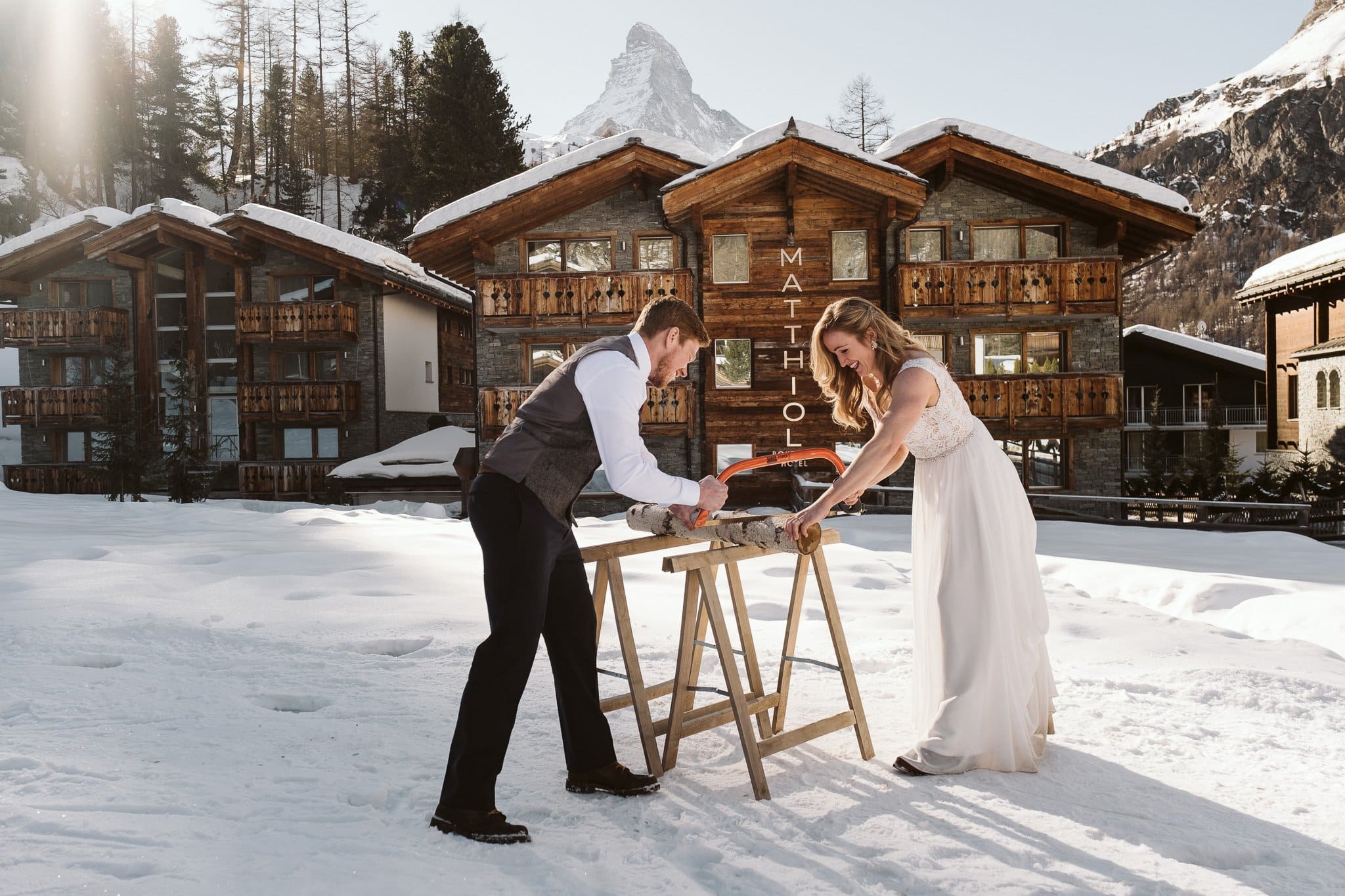 Bride and groom baumstamm sagen in front of Matthiol Boutique Hotel in Zermatt, Switzerland.