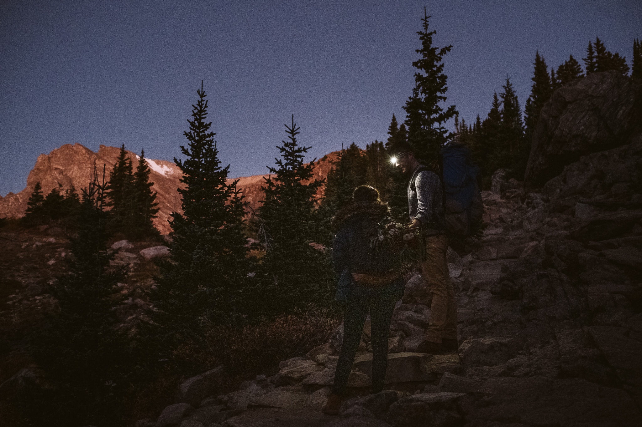 Couple hiking by headlamps