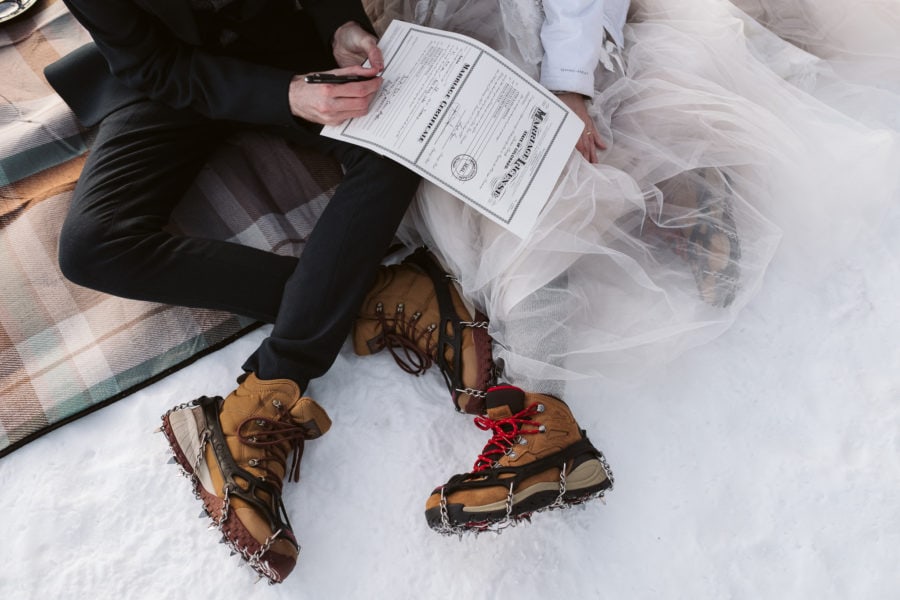 Hiking boots with micro spikes at a winter elopement. 