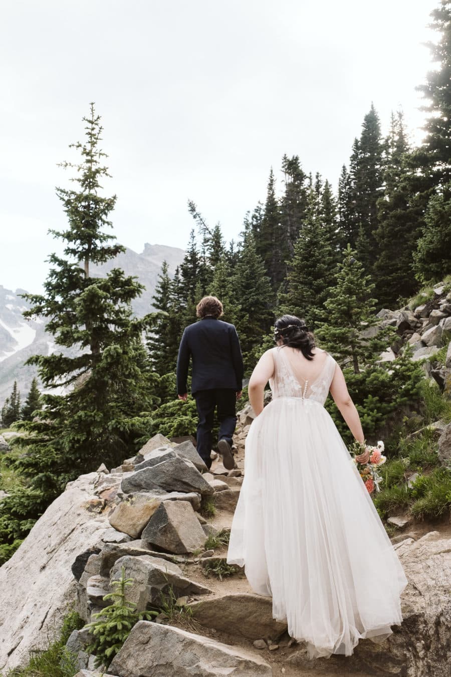 Bride and groom hiking in the Colorado mountains
