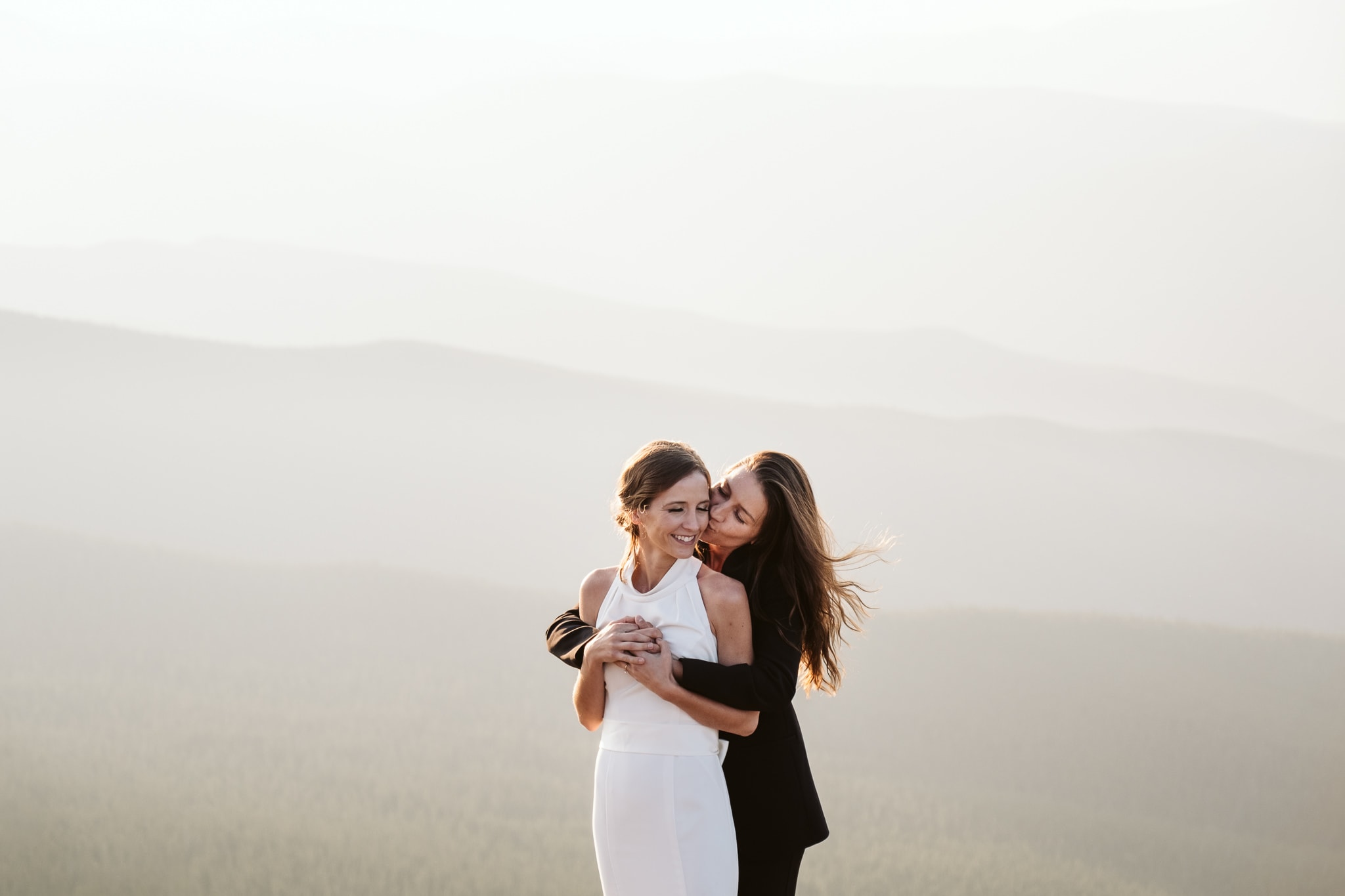 Two brides elope on a Colorado mountain top at sunset