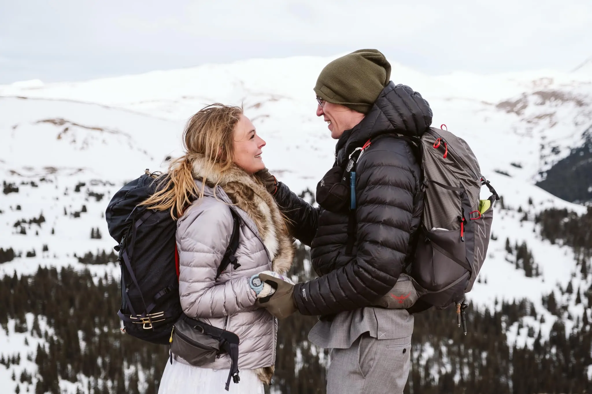 Bride and groom wearing puffy coats at their hiking elopement in Colorado.